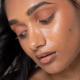 Brown nude lip gloss on model Fitglow Buff