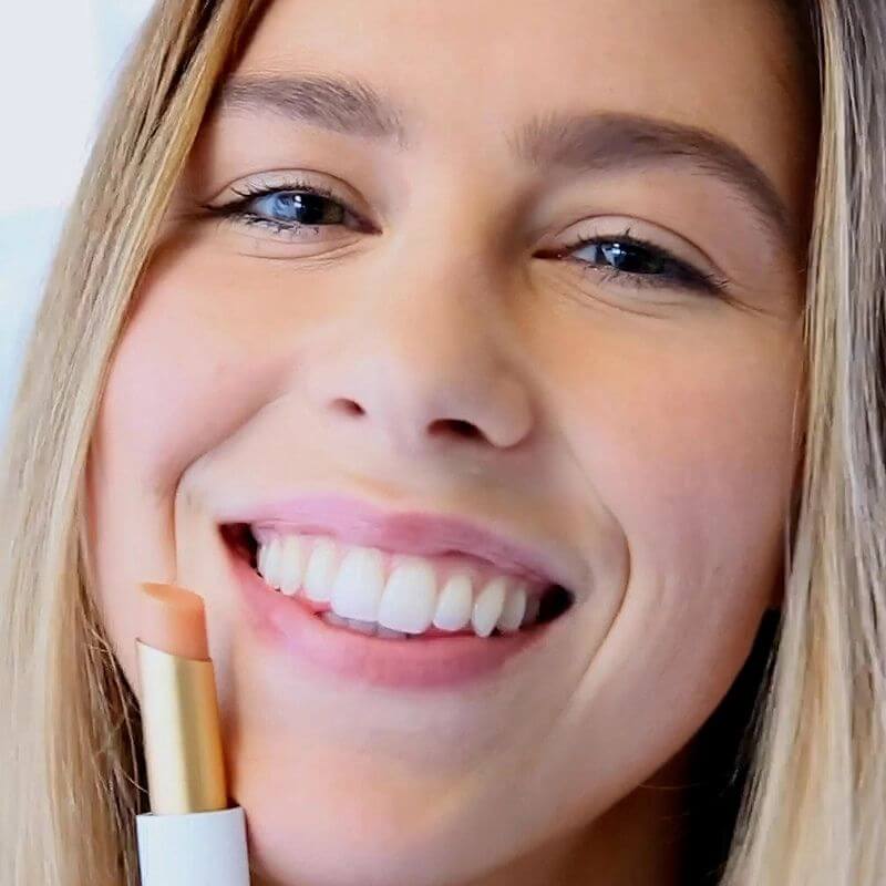 Model wearing clear natural lipstick