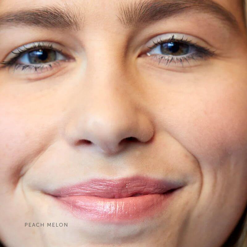 Model wearing Luk Lip Nourish in Peach Melon