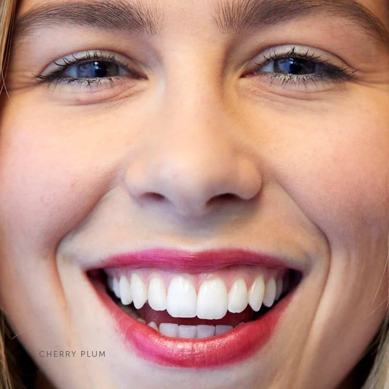 model wearing rich red lipstick - Luk Cherry Plum Lip Nourish