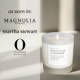 Candle with a label on a light background, featuring mentions of 'Magnolia Journal', 'Martha Stewart', and 'The Oprah Magazine'.