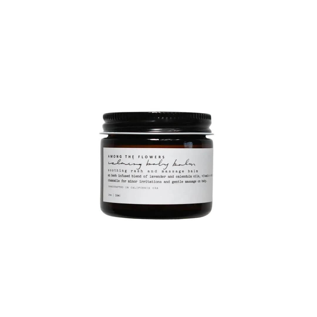 Jar of Among The Flowers calming body balm with a black lid on a white background