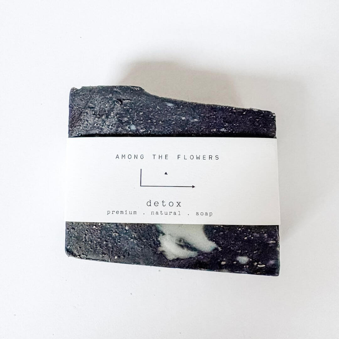 Black and white soap bar with 'Among the Flowers' label on a white background