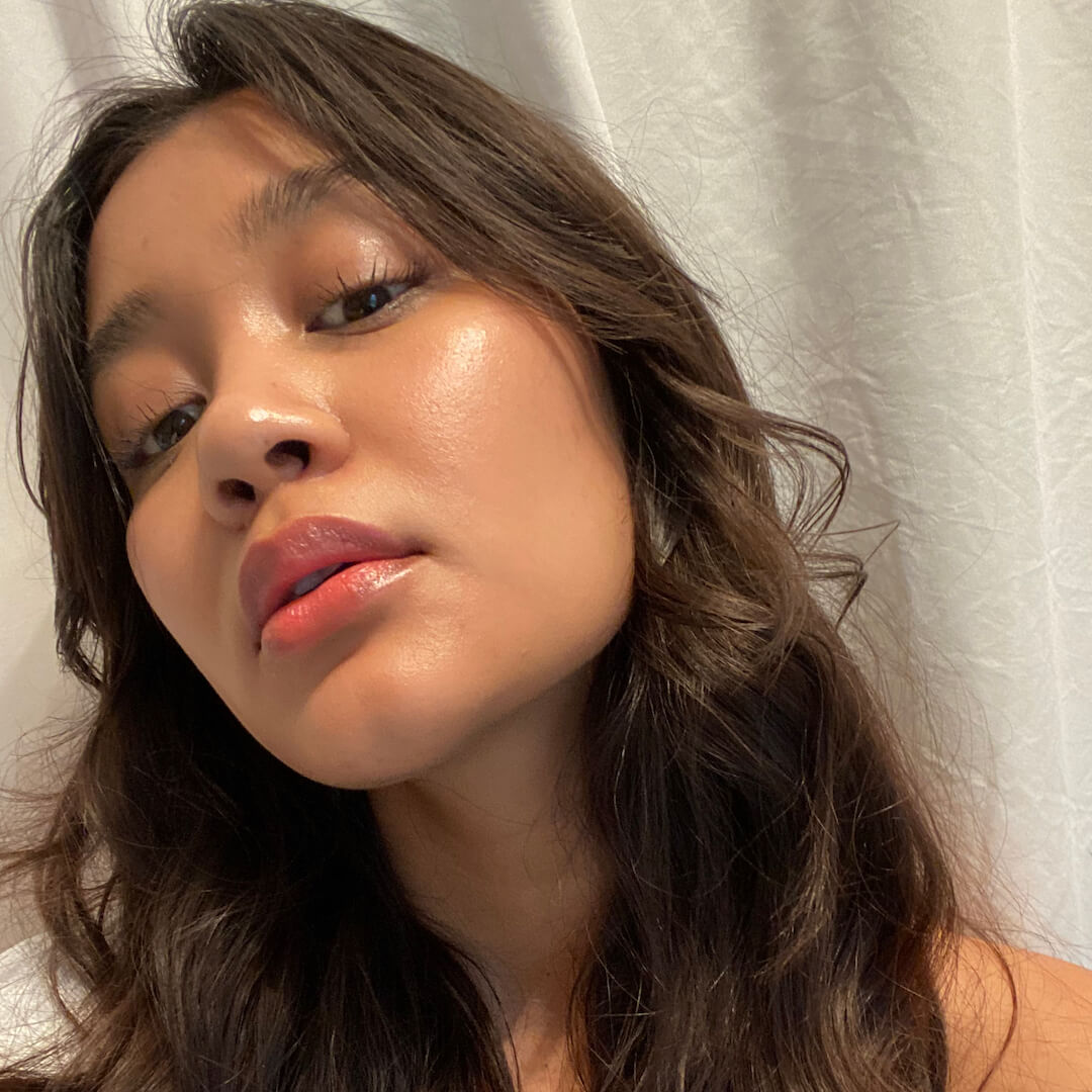 Close-up of a person wearing Axiology Radiance Tinted Dew