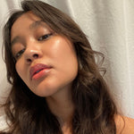 Close-up of a person wearing Axiology Radiance Tinted Dew