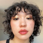 Close-up of a person wearing Axiology Strength Tinted Dew