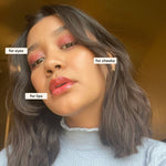 Woman wearing Axiology Clarity makeup on eyes, cheeks, and lips against a warm-toned background