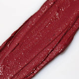 Close-up of a swatch of Axiology Joy makeup stick on a white background
