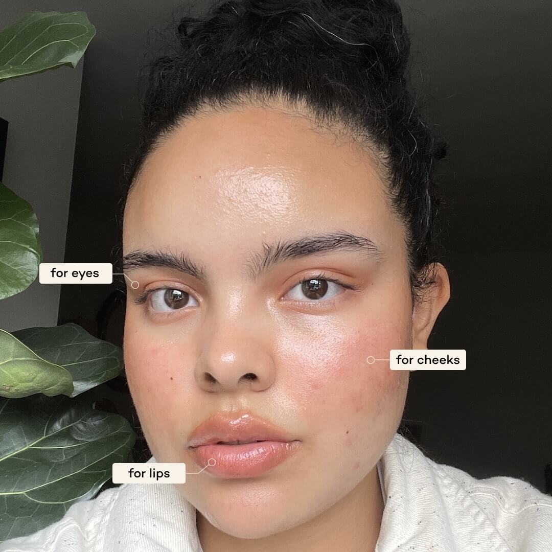 Close-up of a person wearing Axiology Radiance Tinted Dew on eyes, lips and cheeks