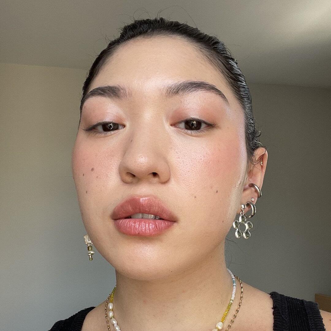 Close-up of a model wearing Axiology Strength Tinted Dew