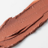 Close-up of a swatch of Axiology Peace brown Tinted Dew on a white background