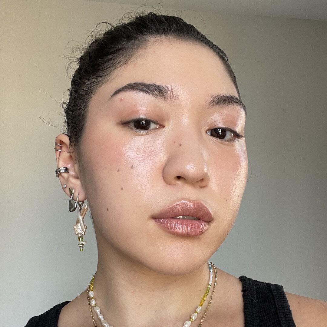 Close-up of a person wearing Axiology Peace Tinted Dew