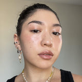 Close-up of a person wearing Axiology Peace Tinted Dew