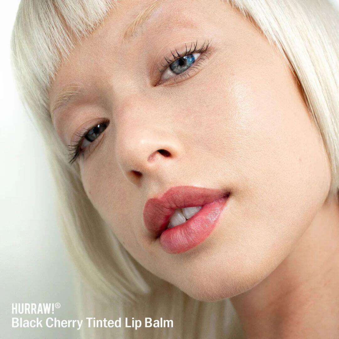 Hurraw tinted lip balm on model