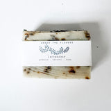 Bar of natural lavender soap from Among the Flowers with a label on a white background