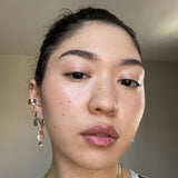 Close-up of a person wearing Axiology Humble Tinted Dew