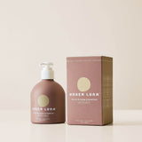 Under Luna Tulsi Bloom shampoo bottle and packaging on a beige background