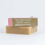 Bar of Little Seed Farm Holiday soap with a holiday-themed packaging label on a white background