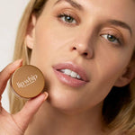 Model holding Kari Gran peptide lip whip