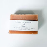 Bar of Among the Flowers Pink Grapefruit soap with a label on a white background