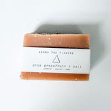 Bar of Among the Flowers Pink Grapefruit soap with a label on a white background