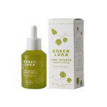 Under Luna Hop-Infused Growth Serum in a translucent olive-green dropper bottle next to its white packaging box with green hop illustrations.